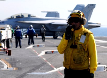 US Navy 090220-N-3610L-315 Aviation Boatswain's Mate 3rd Class Leonel Polanco readies an aircraft handling team to reposition a C-2A Greyhound