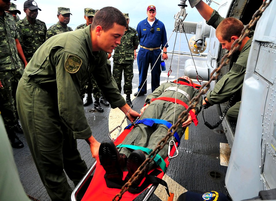 US Navy 090221-N-4774B-017 Lt.jg Rebecca Faunt plays the role of a casualty being assisted by a helicopter lift during a tour of USS Lake Champlain (CG 57) by members of the Maldives National Defense Force Coast Guard