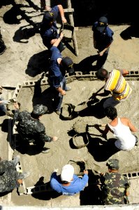 US Navy 090221-N-8546L-817 Sailors assigned to the amphibious command ship USS Blue Ridge (LCC 19) help pour concrete