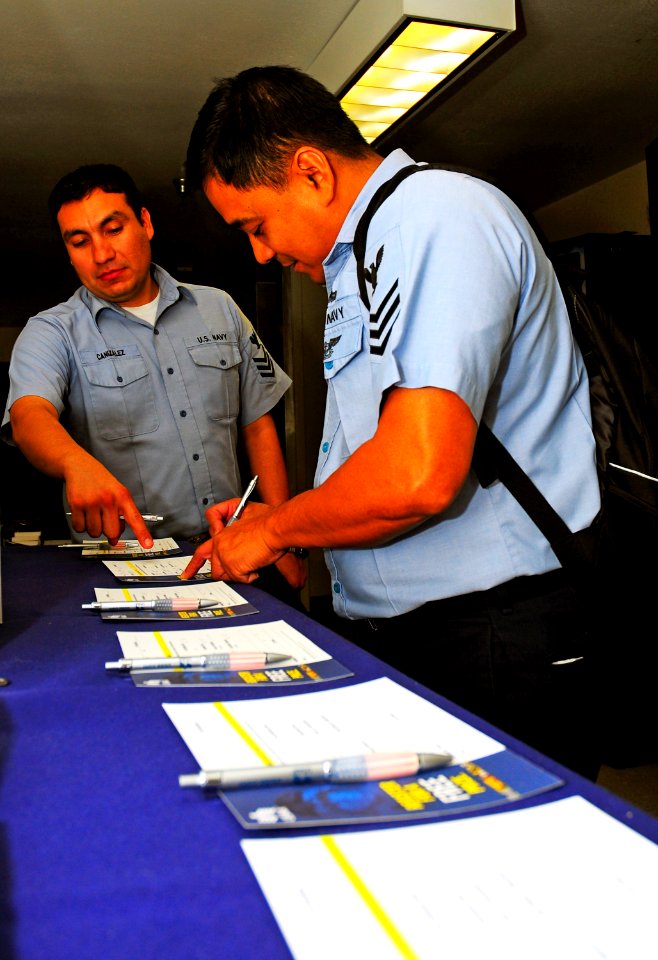 US Navy 090223-N-8878B-010 Machinist's Mate 1st Class Arturo Dedios fills out a survey to receive money saving information from the United Services Automobile Association