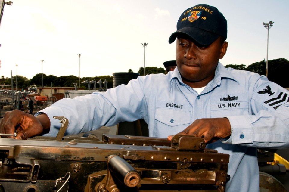 US Navy 090226-N-6674H-003 Mate 1st Class Max Gassant works on a .50 caliber machine gun