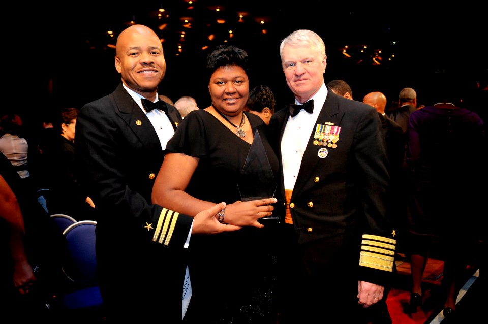 US Navy 090221-N-8273J-081 Cmdr. Roger Isom and wife, Lisa, pose for a photo with Chief of Naval Operations Adm. Gary Roughead at the conclusion of the 2009 Black Engineer of the Year Awards