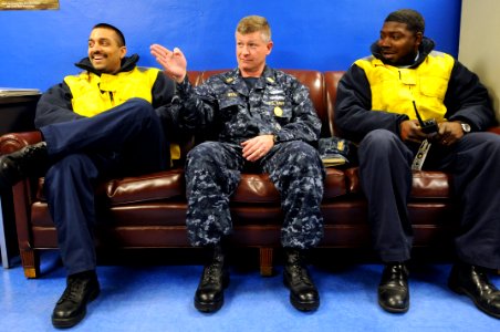 US Navy 090220-N-9818V-125 Aviation Boatswain's Mate (Equipment) 3rd Class Marcus Allen and Aviation Boatswain's Mate (Handling) 1st Class Nathaniel Sukal sit and talk with Master Chief Petty Officer of the Navy Rick West