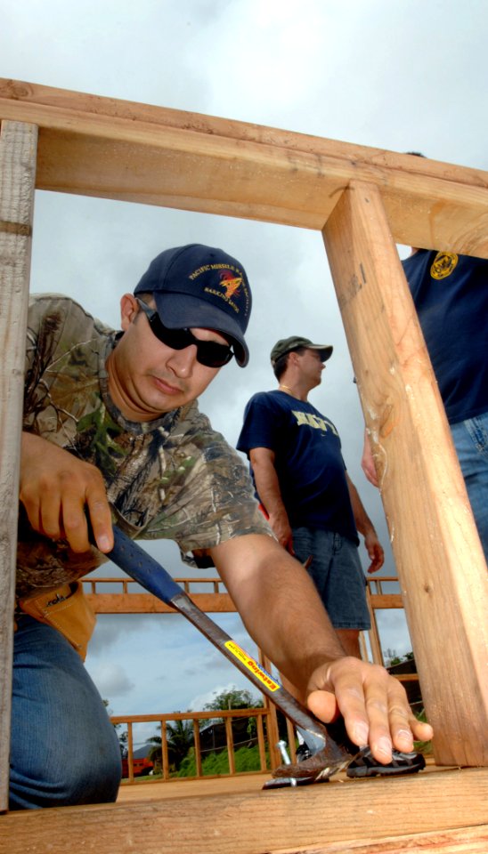 US Navy 090220-N-0535P-143 Aviation Support Equipment Technician 2nd Class Michael Sanchez builds wall frames during a low-income housing project