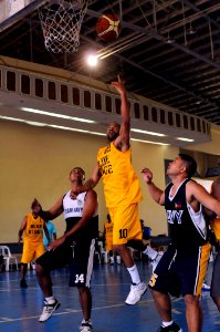 US Navy 090221-N-3830J-322 Religious Program Specialist 1st Class Dana Saunders, assigned to the amphibious command ship USS Blue Ridge (LCC 19), takes a lay-up shot