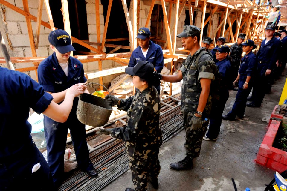 US Navy 090221-N-8546L-385 Sailors embarked aboard the amphibious command ship USS Blue Ridge (LCC 19) work with members of the Armed Forces of the Philippines Navy to transfer concrete