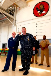 US Navy 090220-N-3013W-093 Master Chief Petty Officer of the Navy (MCPON) Rick West is assisted by Aviation Structural Mechanic 3rd Class Tifani Vesey in delivering a Navy