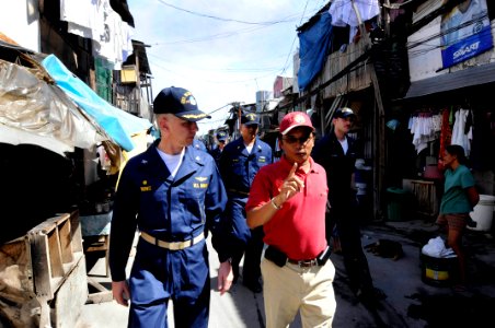 US Navy 090221-N-8546L-317 Capt. Thom W. Burke, commanding officer of the amphibious command ship USS Blue Ridge and crew are on a tour of a village under the care of Gawad Kalinga by program director Ed Mabuti