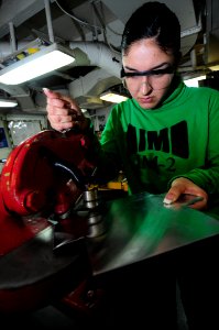 US Navy 090221-N-3946H-016 viation Structural Mechanic Airman Sandra Covarrubias uses a metal shearer to fabricate aircraft replacement parts photo