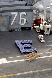 US Navy 090224-N-1635S-001 Sailors stand in formation to spell an