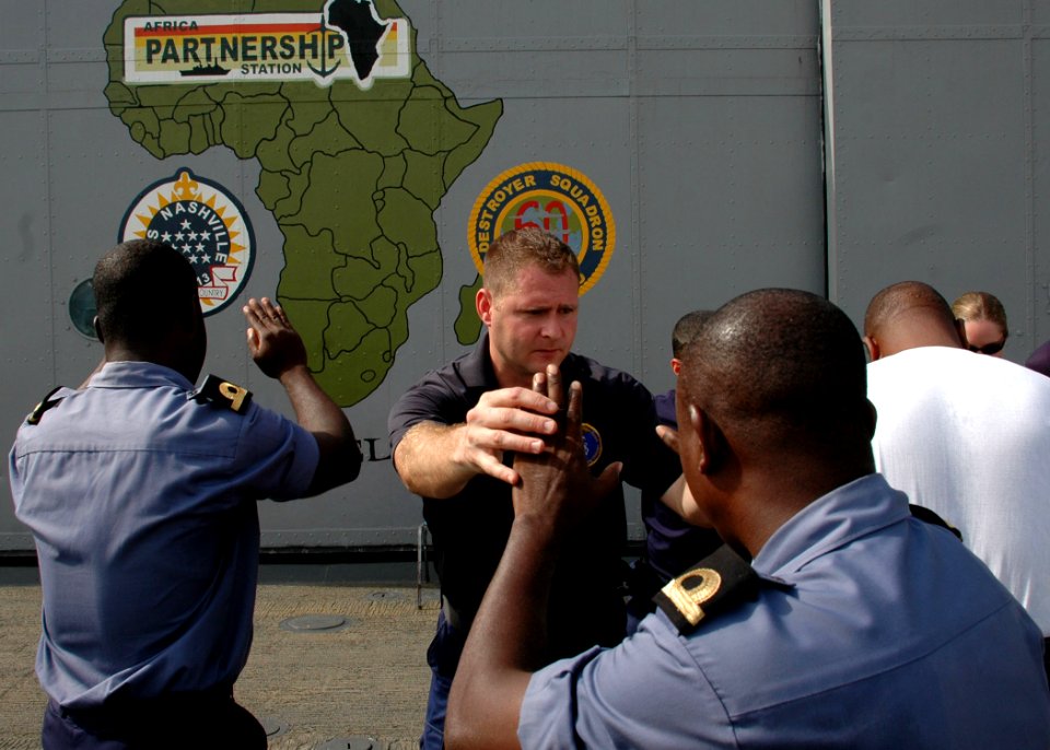 US Navy 090225-N-1655H-026 Coast Guard Boatswain's Mate 2nd Class Gregory Belkin works with a Ghanaian Sailor during visit, board, search ^ seizure training
