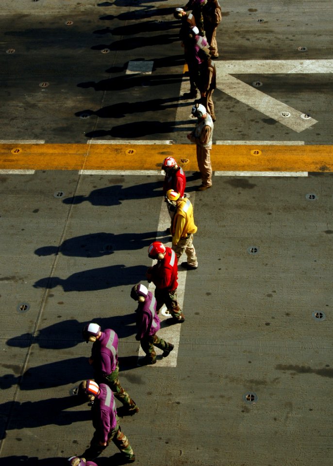 US Navy 090223-N-4236E-123 Sailors and Marines perform a foreign object debris walk-down on the flight deck of SS Iwo Jima (LHD 7)