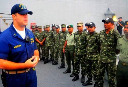 US Navy 090221-N-4774B-008 Ensign Seth Marcusa gives members of the Maldives National Defense Force a tour of USS Lake Champlain (CG 57)
