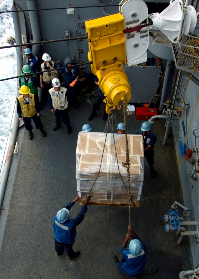 US Navy 090224-N-1251W-111 Deck department Sailors assigned to the amphibious dock landing ship USS Harpers Ferry (LSD 49) receive a pallet of supplies from the Military Sealift Command fleet replenishment oiler USNS John Ericc