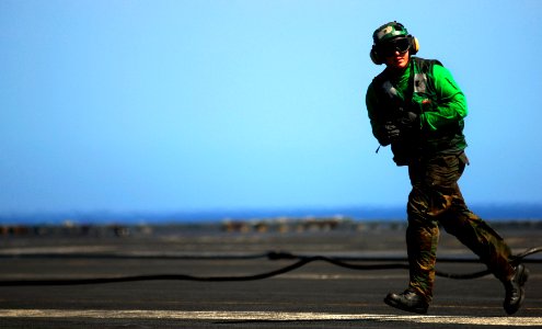 US Navy 090225-N-9928E-049 Aviation Boatswain's Mate (Equipment) Airman William Dail checks the arresting gear cable