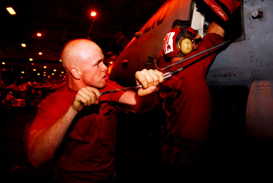 US Navy 090226-N-2475A-206 Lance Cpl. Tyler Sproles, from Beeville, Texas, uses a speed handle to check for loose rounds in a GAU-4 20mm Vulcan M61A2 20mm automatic gun in an F-A-18C Hornet