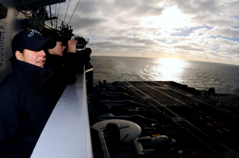US Navy 090226-N-9760Z-010 Intelligence Specialist 3rd Class Annette Ruiz and Intelligence Specialist 2nd Class Kayla Botts observe a vertical replenishment