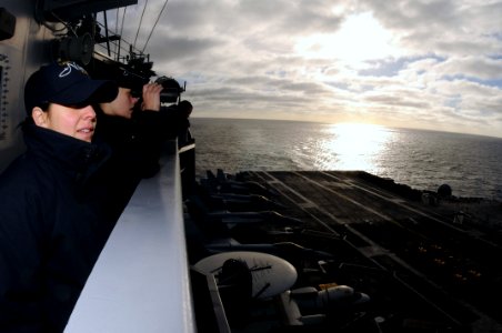 US Navy 090226-N-9760Z-010 Intelligence Specialist 3rd Class Annette Ruiz and Intelligence Specialist 2nd Class Kayla Botts observe a vertical replenishment