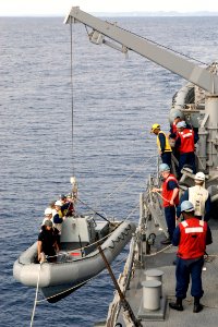 US Navy 090228-N-9123L-001 Sailors lower a rigid hull inflatable boat for a personnel transfer off the coast of Okinawa, Japan