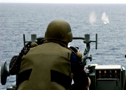 US Navy 090226-N-1251W-096 Chief Fire Controlman Scott Vlaming fires the MK-38 25mm machine gun during a live fire shoot aboard the amphibious dock landing ship USS Harpers Ferry (LSD 49)