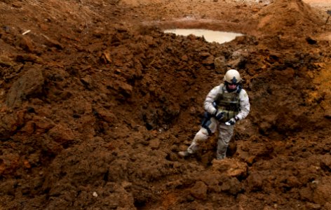 US Navy 090226-N-7090S-114 t. Andrew Scott performs a post-blast analysis after the detonation of an improvised explosive device (IED)