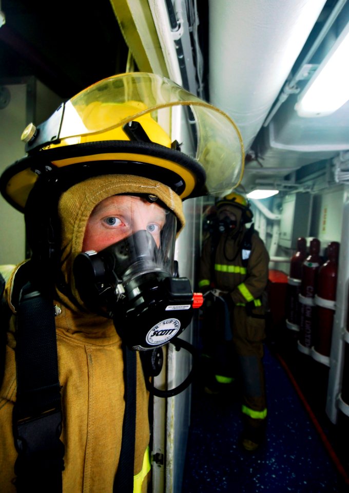 US Navy 090226-N-6538W-244 Damage Controlman Fireman Robert Domozych returns to his hose team after fighting a simulated fire