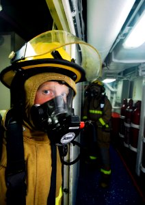 US Navy 090226-N-6538W-244 Damage Controlman Fireman Robert Domozych returns to his hose team after fighting a simulated fire