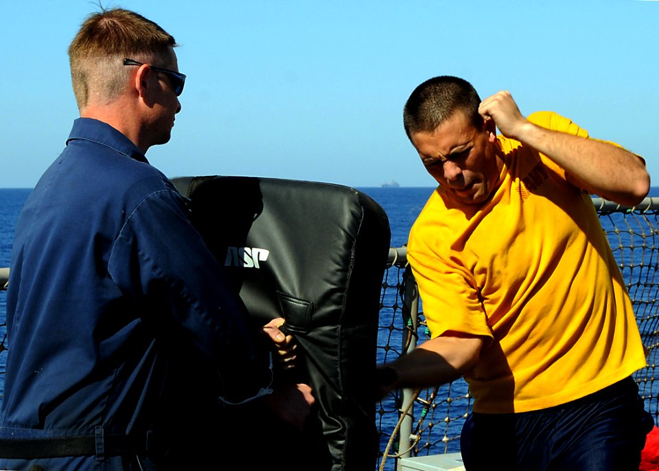 US Navy 090226-N-1082Z-025 Electronics Technician 3rd Class Kenny W. Rugg uses a baton to defend himself from Aviation Electrician's Mate 2nd Class Michael Piechowski after being sprayed with Oleoresin Capsicum (OC)
