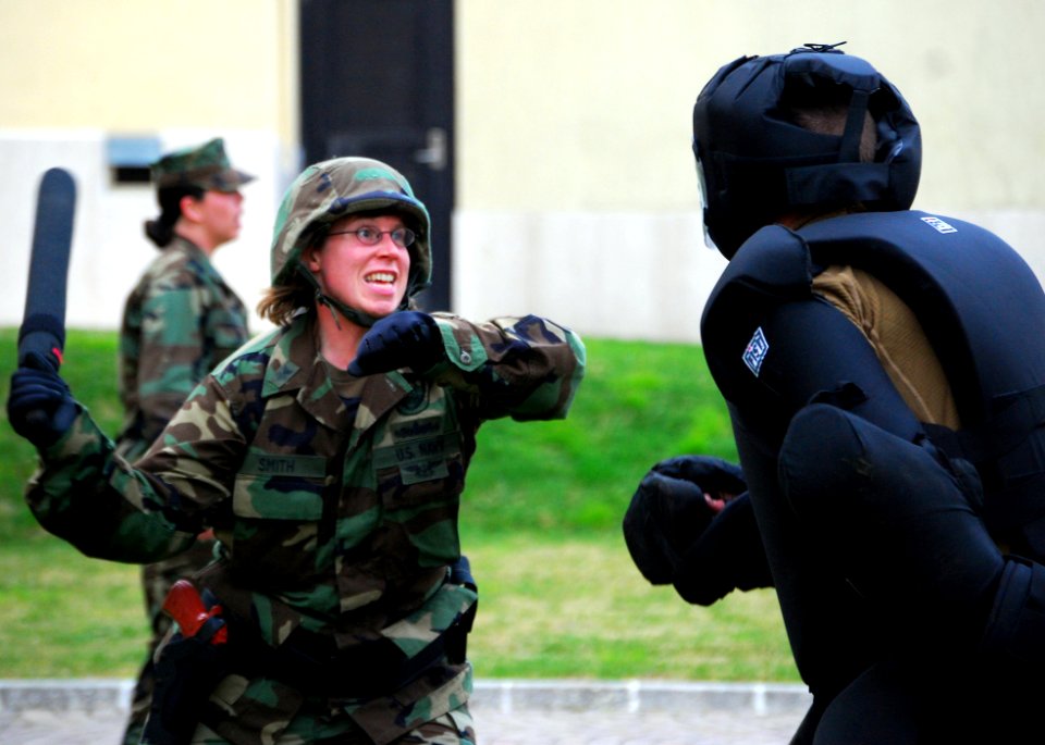US Navy 090227-N-4044H-101 Master-at-Arms 1st Class Andrea Smith strikes a simulated aggressor with a baton during a team-building obstacle course at Naval Support Activity Naples