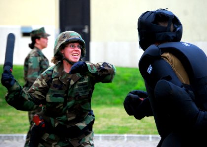 US Navy 090227-N-4044H-101 Master-at-Arms 1st Class Andrea Smith strikes a simulated aggressor with a baton during a team-building obstacle course at Naval Support Activity Naples