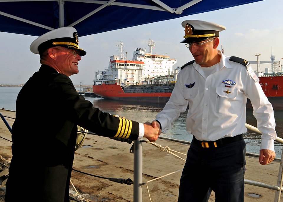 US Navy 090304-N-1082Z-002 Israel Naval Forces Rear Adm. Ram Rutberg, commander of Haifa Naval Base, is greeted by Capt. Mark D. Genung, commanding officer of the guided-missile cruiser USS Vella Gulf (CG 72) on the ship's quar