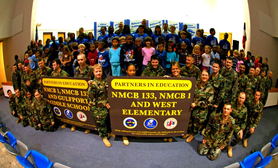 US Navy 090302-N-7367K-002 Children and staff of Gulfport Central Middle School and West Elementary School stand with Seabees