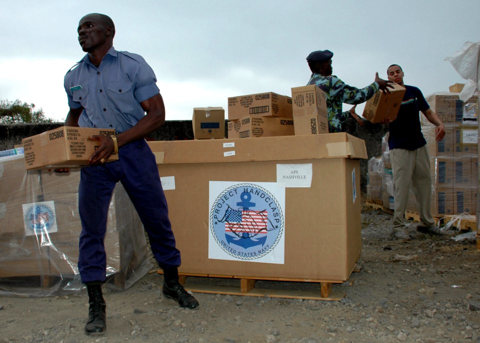 US Navy 090226-N-1655H-075 Ghanaian, Cameroonian and U.S. Navy Sailor load donated Project Handclasp materials for a community relations project