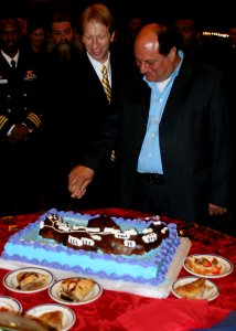 US Navy 090303-N-6764G-121 U.S. Ambassador to Greece Daniel Speckhard, left, and Santorini, Greece Mayor Angelos Roussos cut a ceremonial cake during a reception aboard the amphibious transport dock ship USS San Antonio (LPD 17