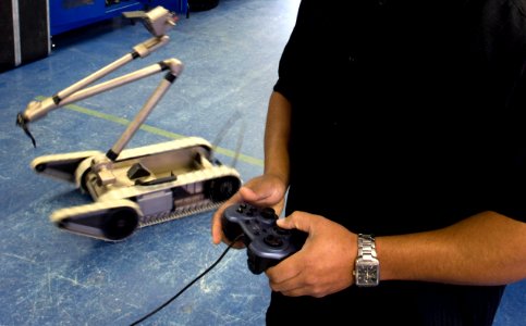 US Navy 090226-N-7090S-272 Warren Tibbs, a robot operator at the Navy Explosive Ordnance Disposal (EOD) Technical Division, Indian Head, Md., uses a PlayStation controller to demonstrate the maneuverability of the Pac-Bot
