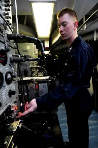 US Navy 090227-N-3946H-034 Aviation Electronics Technician 3rd Class Arthur Randall troubleshoots an ARN-84 tactical air navigation computer