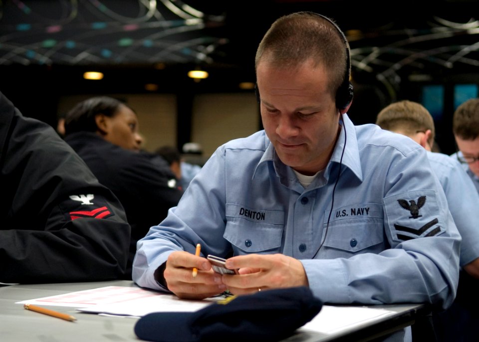 US Navy 090305-N-2013O-011 Musician 2nd Class Dirk Denton, from Brooklyn, N.Y., listens to an MP3 player during the Navy-wide E-6 advancement exam at Fleet Activities Yokosuka