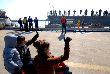 US Navy 090229-N-7544A-092 Family members wave good-bye to Sailors aboard the guided-missile destroyer USS Laboon (DDG 58) as the ship leaves its homeport of Norfolk for a six-month deployment