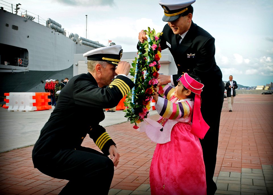 US Navy 090305-N-3830J-031 Capt. Thom W. Burke, left, commanding officer of the amphibious command ship USS Blue Ridge (LCC 19), receives a flower wreath from the daughter of a Republic of Korea naval officer
