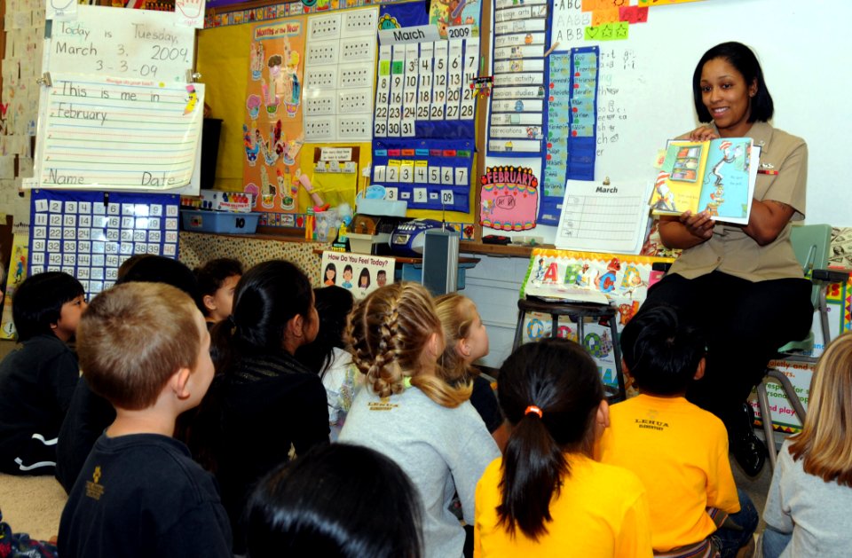 US Navy 090303-N-3666S-003 Boatswain's Mate 2nd Class Rasheema Newsome, assigned to Commander, Navy Region Hawaii, reads Dr. Seuss' The Cat in the Hat to kindergarten students at Lehua Elementary School
