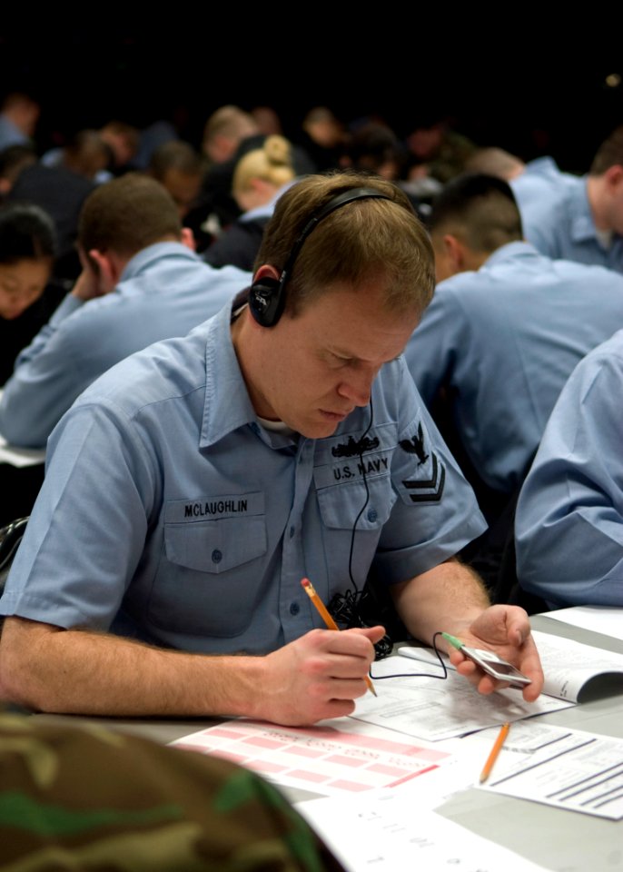 US Navy 090305-N-2013O-019 Musician 2nd Class Kenny McLaughlin, from Austin, Texas, listens to an MP3 player during the Navy-wide E-6 advancement exam at Fleet Activities Yokosuka