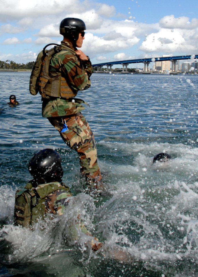 US Navy 090305-N-5366K-025 A Special Warfare Combatant-craft Crewman candidate jumps into Coronado Bay for a floatation check photo