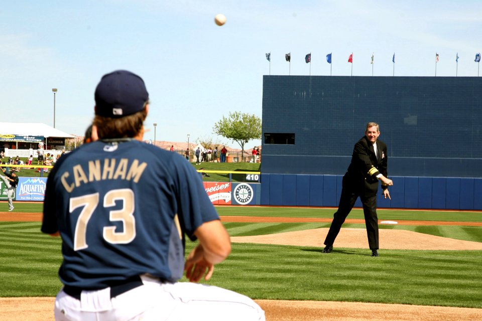 US Navy 090306-N-3271W-034 Rear Adm. Leendert R. Hering Sr., commander of Navy Region Southwest, throws out the first pitch to San Diego Padres pitcher Mitch Canham before a pre-season game at Peoria Sports Complex