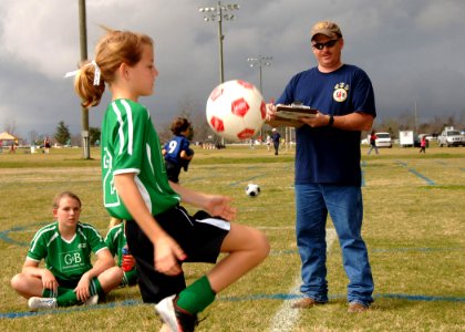 US Navy 090228-N-8816D-178 Chief Builder Robert Tyree, right, assigned to Naval Mobile Construction Battalion (NMCB) 133, counts the number of times each participant can juggle a soccer ball without dropping it during a 2009 Gr photo