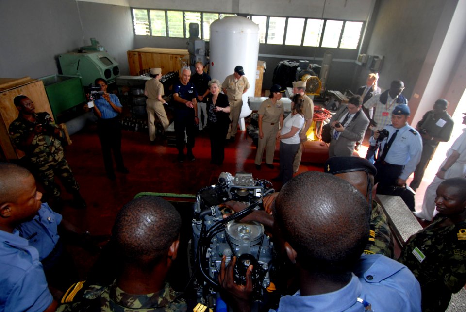 US Navy 090302-N-1688B-042 Mary Yates, deputy commander for Civil-Military Activities, U.S. Africa Command, observes Ghanaian and Mozambiquen sailors repair a small boat outboard motor while taking a tour of Sekondi Naval Base