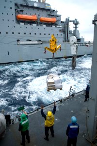US Navy 090304-N-9123L-003 Sailors aboard the guided-missile destroyer USS John S. McCain (DDG 56) receive a pallet of supplies from the Military Sealift Command Dry Cargo-Ammunition ship USNS Alan Shepard (T-AKE 3)