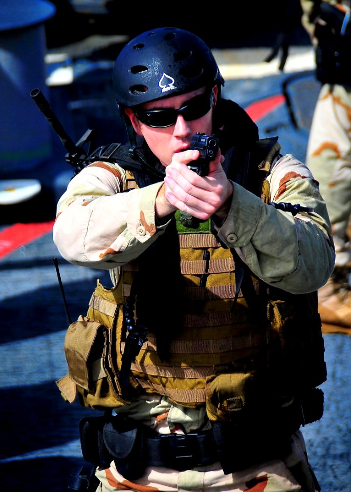 US Navy 090304-N-4774B-012 A member of a visit, board, search, and seizure team from the U.S. Coast Guard high endurance cutter Boutwell (WHEC 719) maintains a secure position with a Baretta 9 mm handgun