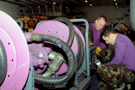 US Navy 090304-N-3589B-033 Aviation Boatswain's Mate (Fuel) 3rd Class Ryan Hernandez and Aviation Boatswain's Mate (Fuel) Fireman Timothy Willhite secure defueling carts