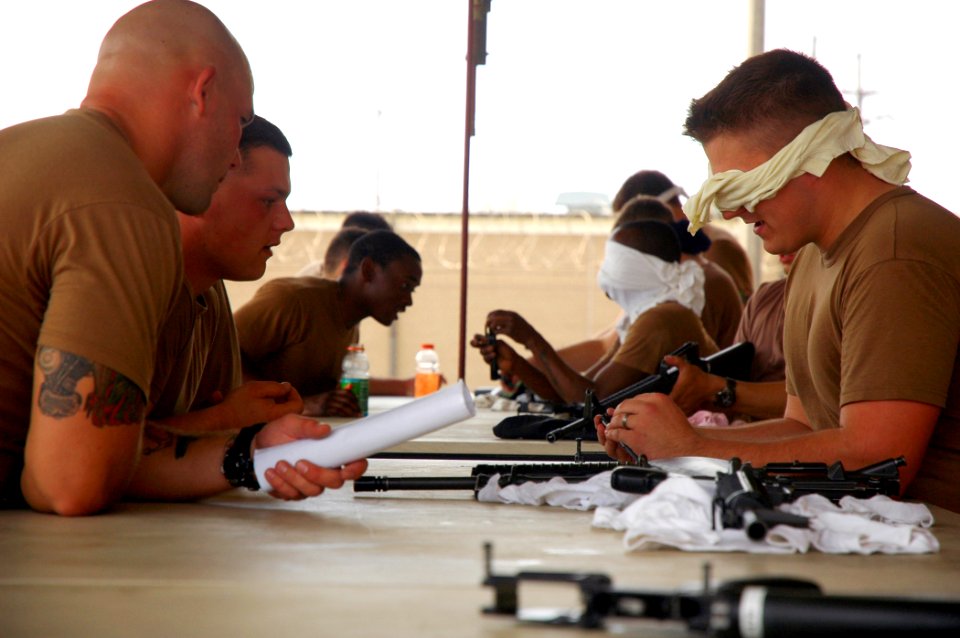 US Navy 090313-N-7367K-012 Seabees assigned to Naval Mobile Construction Battalion (NMCB) 1 are blind-folded while breaking down then reassembling M-16 service rifles