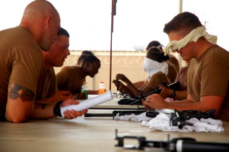 US Navy 090313-N-7367K-012 Seabees assigned to Naval Mobile Construction Battalion (NMCB) 1 are blind-folded while breaking down then reassembling M-16 service rifles